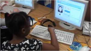 child typing text for VOKI avatar to read aloud